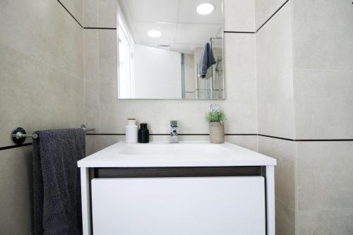 a bathroom with a white sink and a mirror at Villa Malibu 3021 in Vistabella