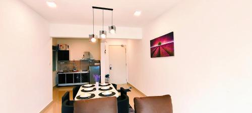 a living room with two chairs and a table at Kulai d putra suites beside ioiMall near JPO and Airport in Kulai