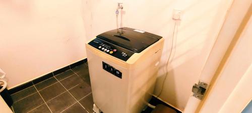 a fax machine sitting in the corner of a bathroom at Kulai d putra suites beside ioiMall near JPO and Airport in Kulai
