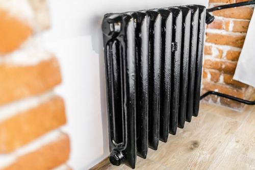 a radiator on a wall next to a brick wall at Rzeźnicza 24 in Wrocław