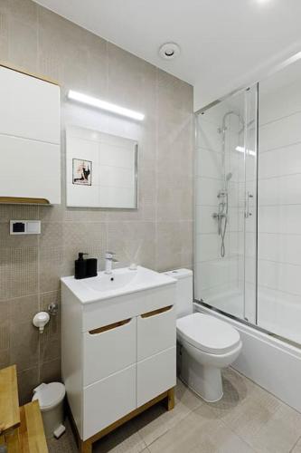 a bathroom with a toilet and a sink and a shower at Rzeźnicza 24 in Wrocław