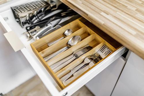 a drawer in a kitchen with utensils in it at Rzeźnicza 24 in Wrocław