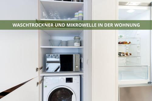 a kitchen with a washing machine in a refrigerator at Die Fichtelsuite 1-6 Pers Ferienwohnung nahe Ochsenkopf Süd 800m in Fleckl in Warmensteinach