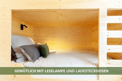 a room with a bed in a wooden house at Die Fichtelsuite 1-6 Pers Ferienwohnung nahe Ochsenkopf Süd 800m in Fleckl in Warmensteinach