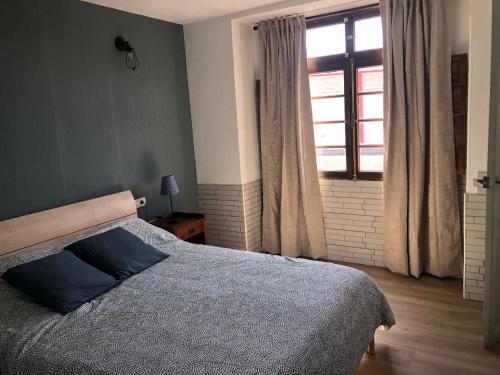 a bedroom with a large bed and a window at Casa Las Enanitas II (Casa Elias) in Fuencaliente de la Palma