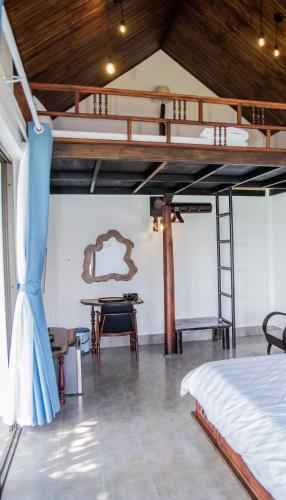 a bedroom with a bunk bed and a table at La Y Riverview in Hue