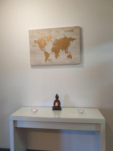 a white table with a map of the world on the wall at Ferienwohnung Maya in Losheim