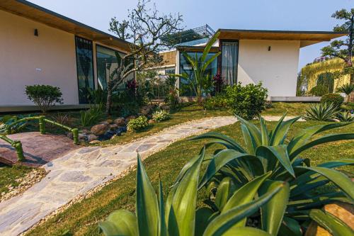 a house with a stone path leading to a house at Melody Retreat - Venuestay in Hòa Bình