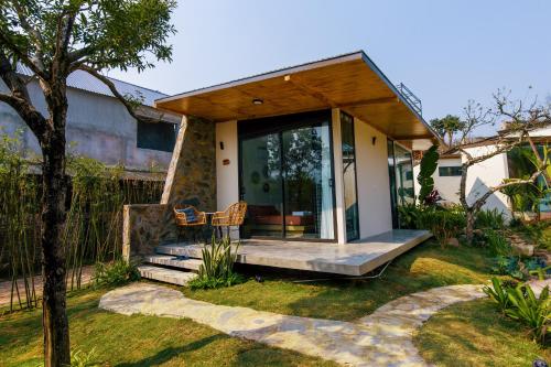 a small house with a porch and glass doors at Melody Retreat - Venuestay in Hòa Bình