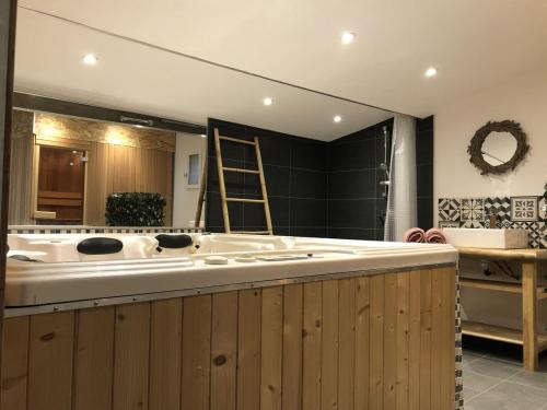 a large bathroom with a tub and a large mirror at Mas Allard in Tarascon