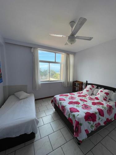a bedroom with a bed and a window at Amanzimtoti Beachfront Holiday Apartment , Flat No 23, Ezulweni in Durban
