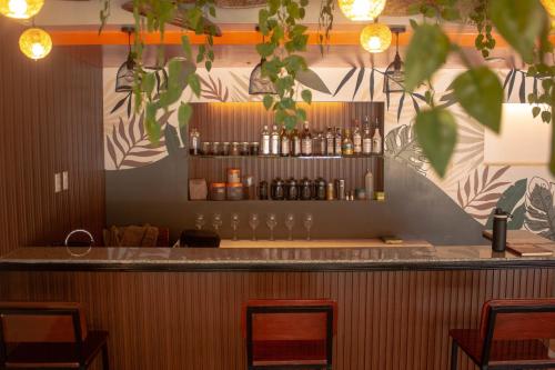 a bar in a restaurant with glasses on the wall at Wanderlust Bed & Breakfast in Puerto Princesa City