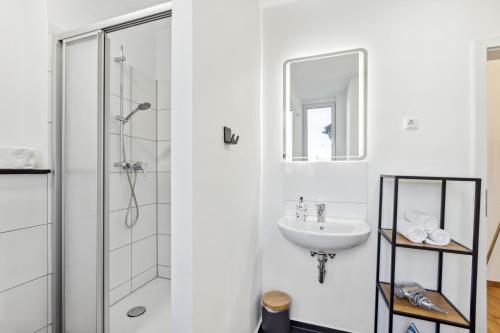 a white bathroom with a shower and a sink at Mark 51-7 - Workplace - Netflix - Washer Dryer - Modern Design in Bochum
