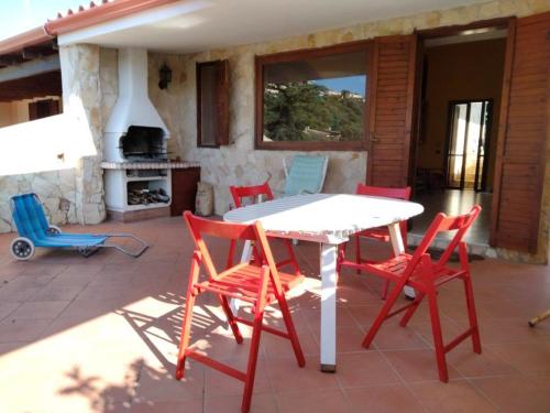 a table and four chairs on a patio at Villa Fiorilla in Geremèas