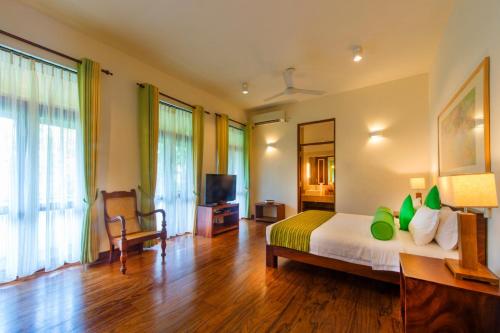 a bedroom with a bed and a television in a room at Zylan Colombo in Colombo