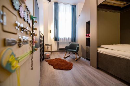 a room with a bed and a chair in it at Hotel Weidenhof in Regensburg