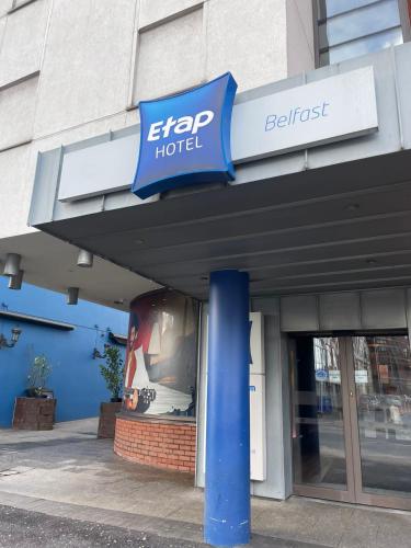 a sign on the front of a building at ibis budget Belfast City Centre in Belfast