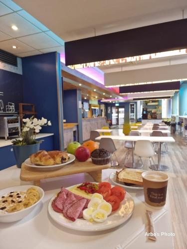 a buffet with plates of food on a table at ibis budget Belfast City Centre in Belfast