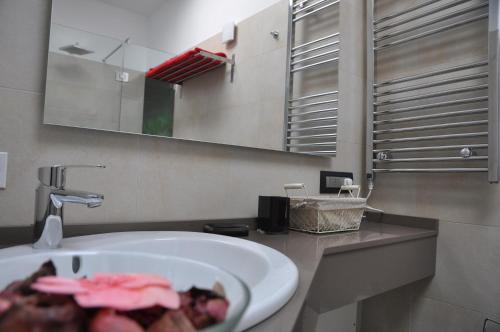 a bathroom sink with a plate of food on it at Ai Santi B&B in Dossobuono