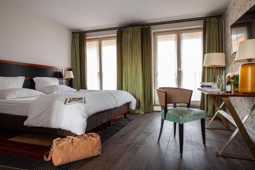 a hotel room with a bed and a table and a chair at Hotel Erbprinz - Gourmet & Spa in Ettlingen