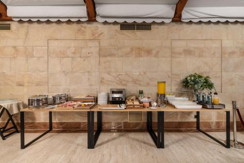 a table with food on it in a room at Exe Astur Plaza in Astorga