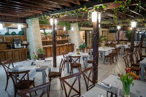 a dining room with tables and chairs in a building at Hotel Secret Garden in Baia-Sprie