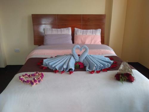 two swans made out of towels on a bed at Hostal Casa del Montañista in Huaraz
