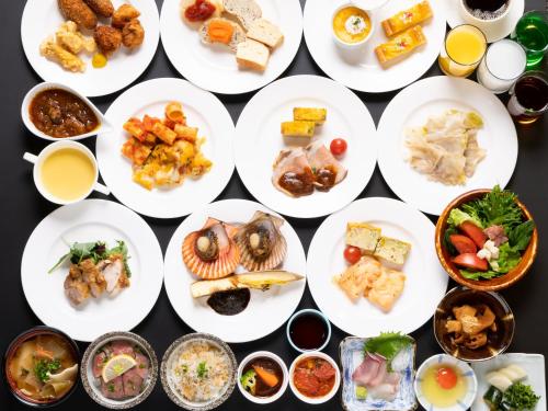 a bunch of plates of food on a table at Spa and Resort Hotel Solage Oita Hiji Beppuwan in Beppu