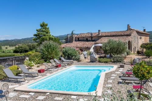 a swimming pool in front of a house at Gîte Coquelicot in Gargas