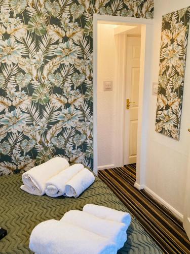 a hallway with two white towels and a wall at Fairfax in Skegness
