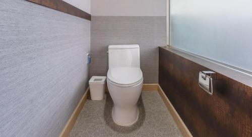 a bathroom with a white toilet in a stall at Hinokki Haesuzzim Resort in Geoje 