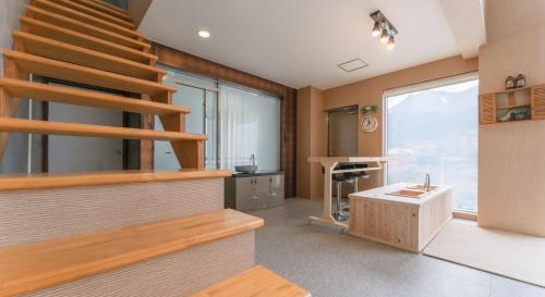 a room with a staircase and a bathroom with a sink at Hinokki Haesuzzim Resort in Geoje 