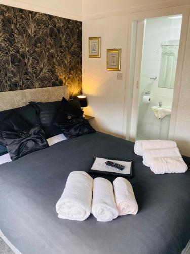 a bedroom with a bed with towels on it at Fairfax in Skegness