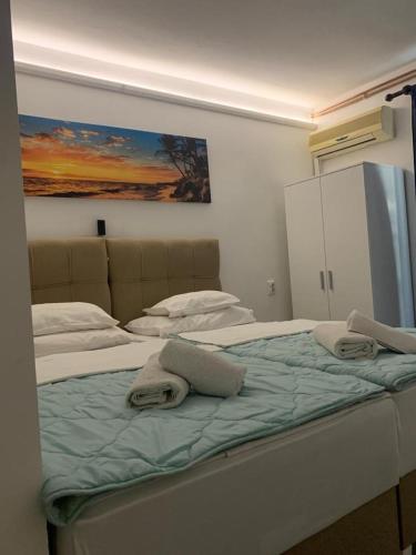 a bedroom with a large bed with towels on it at B&B Sandrina in Bilje