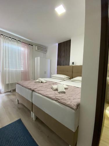 a bedroom with a large bed with two pillows on it at B&B Sandrina in Bilje