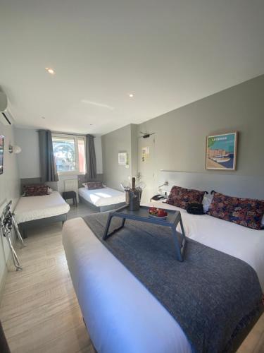 a living room with a couch and a table at Hotel La Tuiliere in Carry-le-Rouet