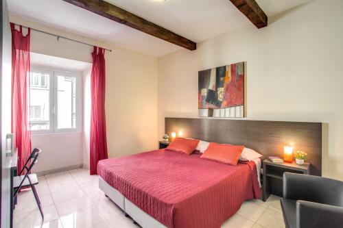 a bedroom with a large bed with red sheets at Hotel Mosaic in Rome