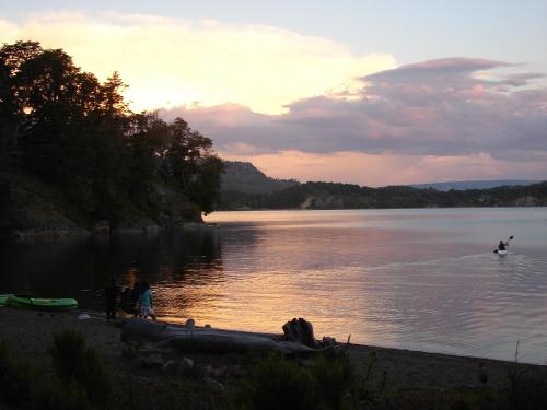 a person is water skiing on a lake at Cabañas Bahiamia in Villa Pehuenia