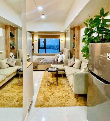 a living room with a couch and a table at Stunning Bayview Studio in Cebu in Guizo