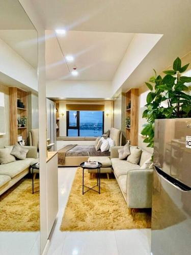 a large living room with a couch and a table at Stunning Bayview Studio in Cebu in Guizo