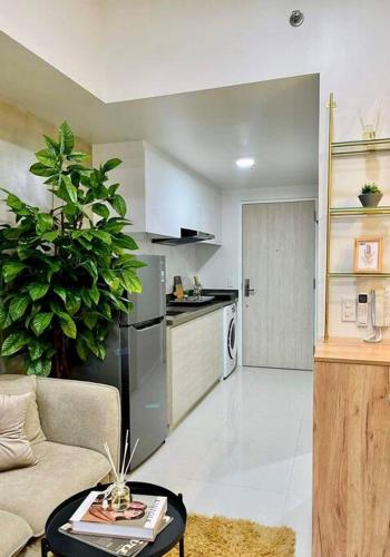 a living room with a couch and a kitchen at Stunning Bayview Studio in Cebu in Guizo