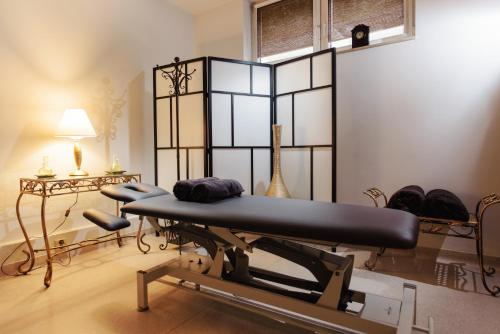 a gym with a bench and a table and a lamp at Lila Medical SPA in Ciechocinek