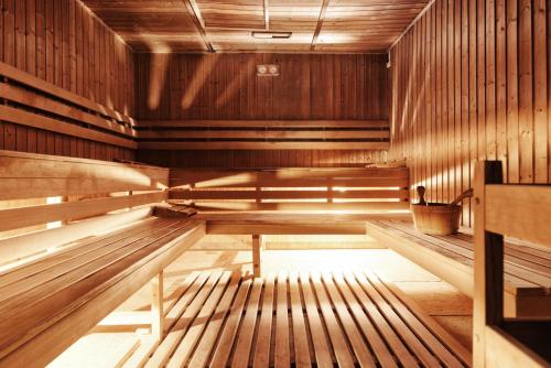 an empty wooden sauna with a bench in the middle at Lila Medical SPA in Ciechocinek
