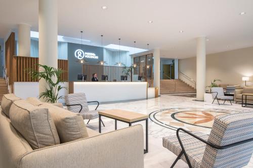 een lobby met banken, tafels en een balie bij Hotel Benidorm East by Pierre & Vacances in Benidorm