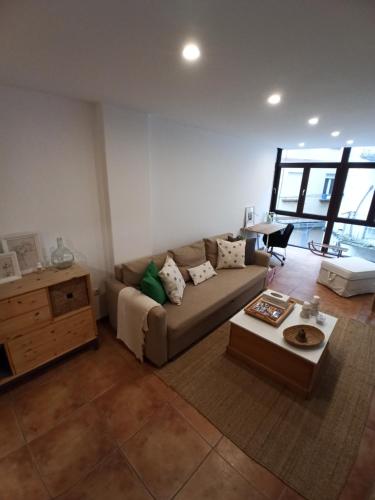 a living room with a couch and a table at La Casita del Camino in Redondela