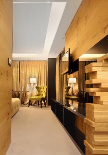 a hotel room with a lobby with a yellow chair at Hotel Nox in Ljubljana