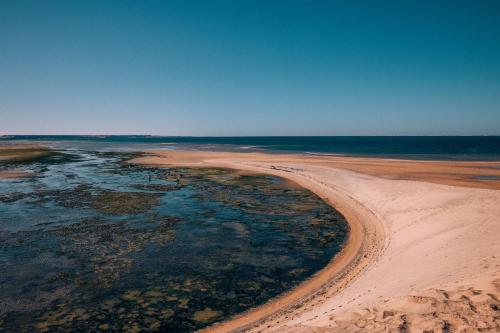 una vista aerea sulla spiaggia di sabbia e acqua di Selina Dakhla a Dakhla