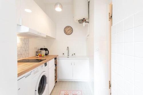 une cuisine blanche avec un évier et une machine à laver dans l'établissement C6 - Studio Rue Félix Faure 2 min Palais Festivals - AC & Balcony, à Cannes