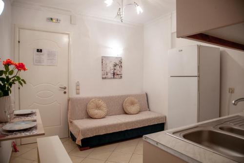 a kitchen with a couch and a white refrigerator at Ethereal Villas Lefkas in Nydri