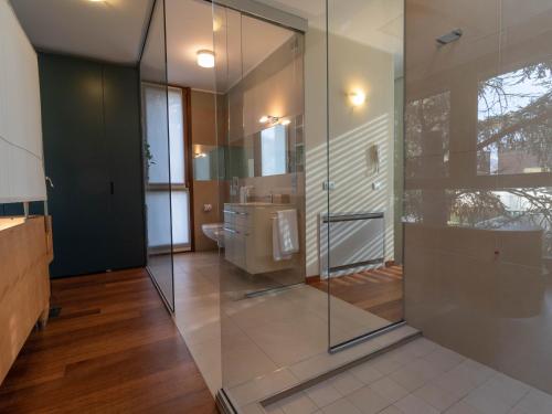 a bathroom with a glass shower and a sink at Mamma Ciccia - ecofriendly villa on Lake Como in Malgrate
